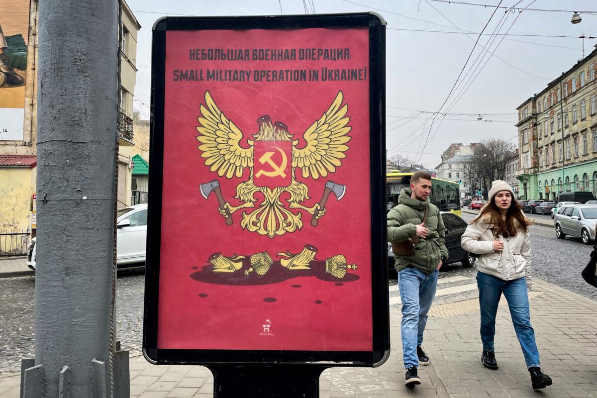 A poster draws on the language Russian President Vladimir Putin has used to describe the war as a "special military operation." The poster depicts a two-headed eagle from Russia's coat of arms which holds the axes it used to decapitate itself. "Small military operation in Ukraine!' the poster reads in Lviv, Ukraine, on March 2022. (Charlotte Cuthbertson/The Epoch Times)