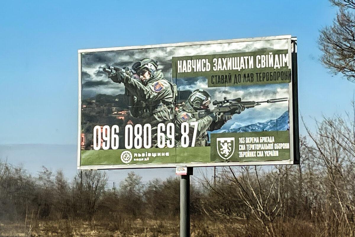 A roadside billboard states: “Learn to protect your home. Join the ranks of territorial defense," in western Ukraine, in March 2022. (Charlotte Cuthbertson/The Epoch Times)
