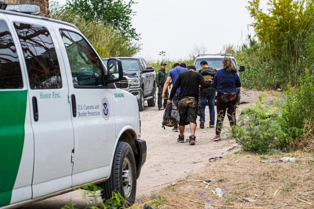 Border Patrol agents apprehend a group of Cubans who just crossed the Rio Grande from Mexico into Eagle Pass, Texas, on April 19, 2022. (Charlotte Cuthbertson/The Epoch Times)