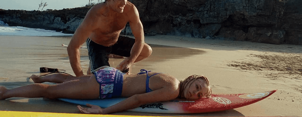 Holt Blanchard (Kevin Sorbo) rescuing Bethany Hamilton (AnnaSophia Robb) after a shark attack, in "Soul Surfer." (Sony Pictures Releasing)