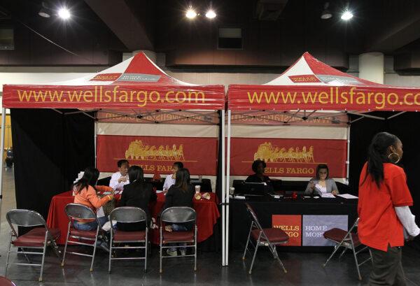 Wells Fargo employees help homeowners go over paperwork during a workshop at the Oakland Convention Center in Oakland, Calif., on April 26, 2010. (Justin Sullivan/Getty Images)