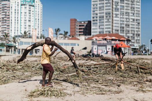Volunteers and members of the public clean up the massive debris at the North Beach following heavy rains earlier the week in Durban, South Africa, on April 15, 2022. (Rajesh Jantilal/AFP via Getty Images)