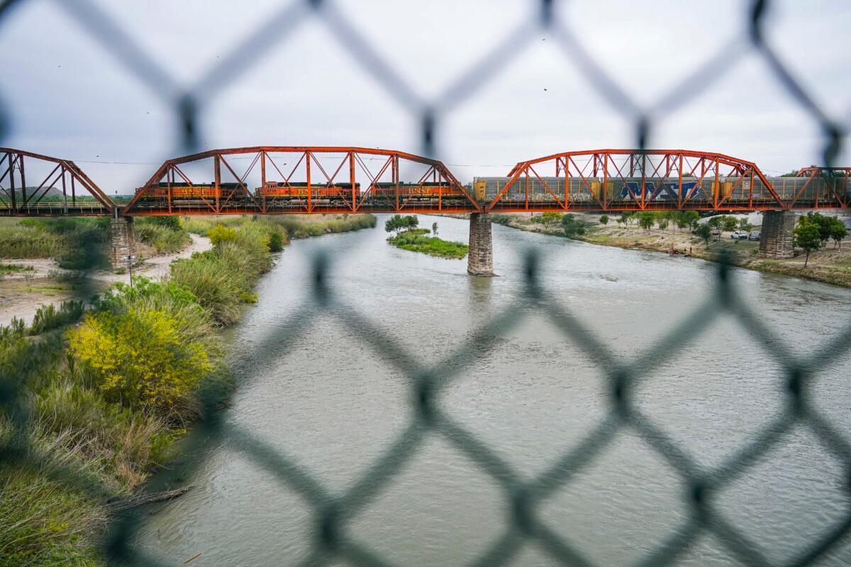 A view of the Rio Grande with Mexico on the right and the United States on the left, from the Camino Real international bridge in Eagle Pass, Texas, on April 19, 2022. (Charlotte Cuthbertson/The Epoch Times)
