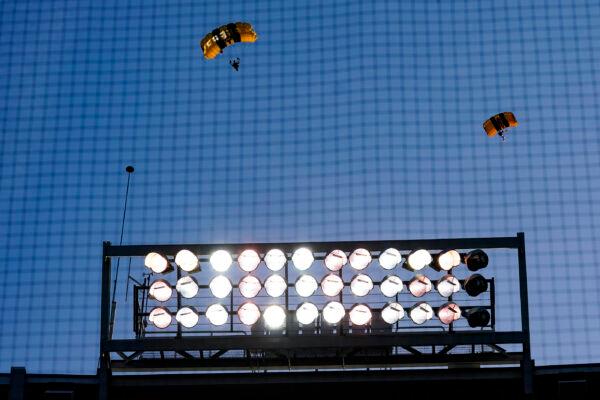 The U.S. Army Parachute Team the Golden Knights descend into National Park before a baseball game between the Washington Nationals and the Arizona Diamondbacks in Washington on April 20, 2022. (Alex Brandon/AP Photo)