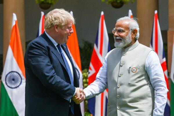 India's Prime Minister Narendra Modi (R) shakes hands with his British counterpart Boris Johnson before a meeting in New Delhi on April 22, 2022. (Prakash Singh /AFP via Getty Images)
