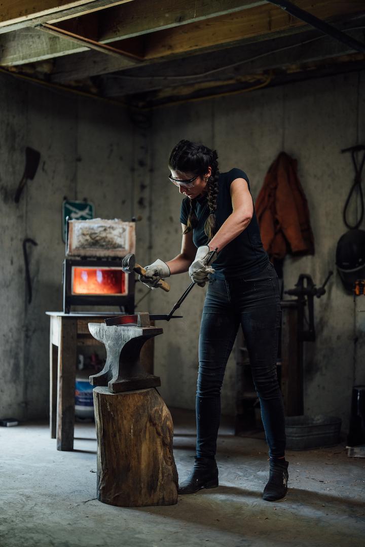Miller's dinner and cheese knives are forged, with the materials first heated in her propane-operated forge, then hammered out on an anvil. (Michael Rubenstein)