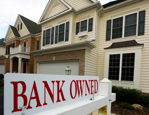 A single-family home with a "Bank Owned" banner to attract buyers is pictured in Centreville, Virginia on April 3, 2009. (PAUL J. RICHARDS/AFP via Getty Images)
