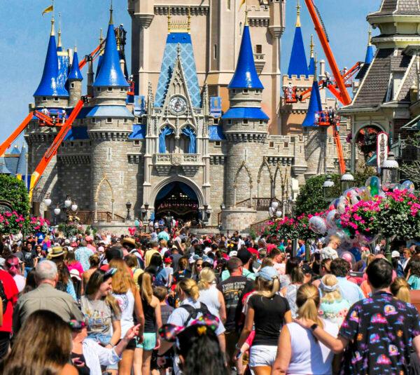 A crowd is shown along Main Street USA in front of Cinderella Castle in the Magic Kingdom at Walt Disney World in Lake Buena Vista, Fla., on March 12, 2020. (Joe Burbank/Orlando Sentinel via AP)