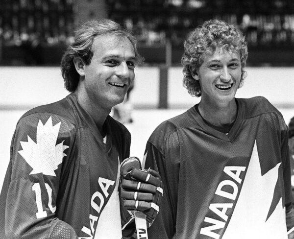 Wayne Gretzky of the Edmonton Oilers (R) and Montreal Canadiens Guy Lafleur are seen during a break in their light skate at the first day of training camp for Team Canada in Montreal, on Aug. 10, 1981. (CP Photo/Ian MacAlpine)