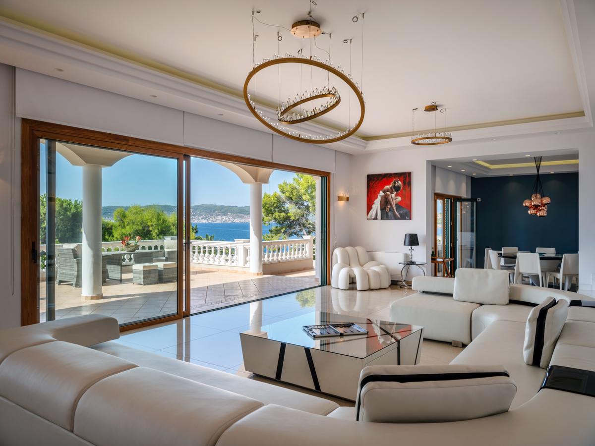 The second-level living spaces provide a magnificent overlook of the stunning Peloponnese Riviera. Throughout, the design suits carefree living. (Courtesy of Greece Sotheby's International Realty)