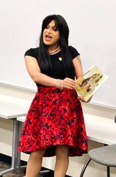 Fernanda, a drag performer who lives in Phoenix, reads passages from "Sparkle Boy," a children's book about a boy curious about his sister's sparkly clothing, during "Drag Queen Story Hour" at Paradise Valley Community College in Phoenix on April 23. The event was part of the college's "Festival of Tales" to promote youth literacy. (Allan Stein/The Epoch Times)
