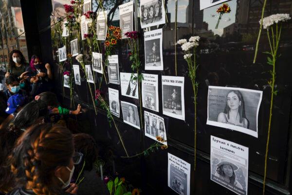 Flowers and portraits of missing women are placed outside the Attorney General office during a protest for the disappearance of Debanhi Escobar, in Mexico City, on April 22, 2022. (Eduardo Verdugo/AP Photo)