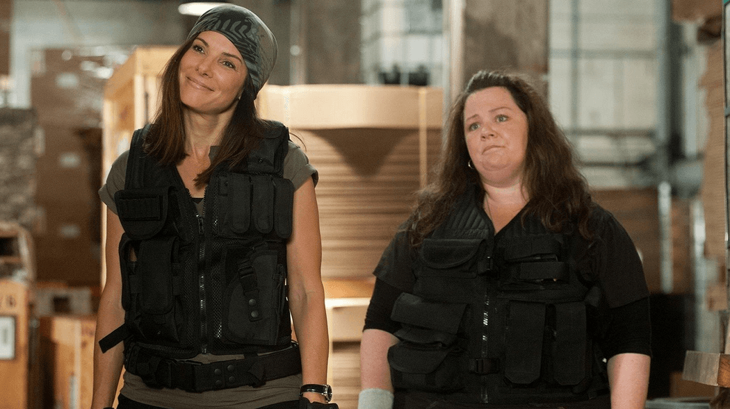 FBI Agent Ashburn (Sandra Bullock, L) and police officer Mullins (Melissa McCarthy) getting set to arrest some perps, in "The Heat." (20th Century Fox)
