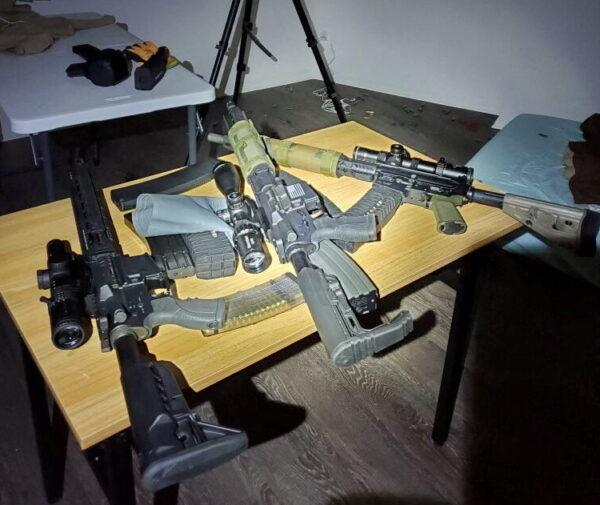 Various firearms are seen on a table at the apartment where the suspect of shooting near the Edmund Burke School was found dead, in Washington, on April 23, 2022. (DC Police Department Handout/Handout via Reuters)