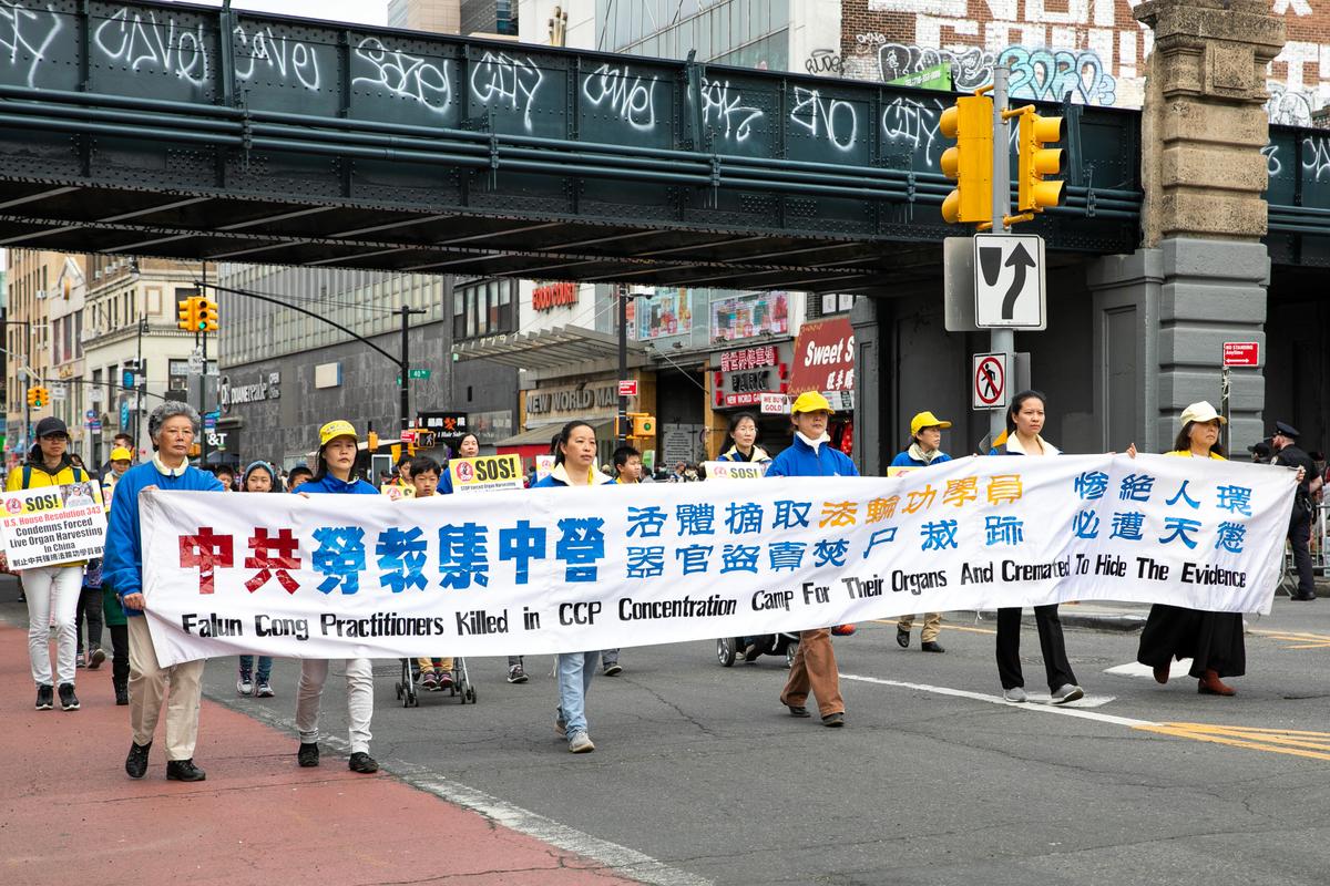 Falun Gong practitioners participate in a parade to commemorate the 23rd anniversary of the April 25th peaceful appeal of 10,000 Falun Gong practitioners in Beijing, in Flushing, N.Y., on April 23, 2022. (Chung I Ho/The Epoch Times)