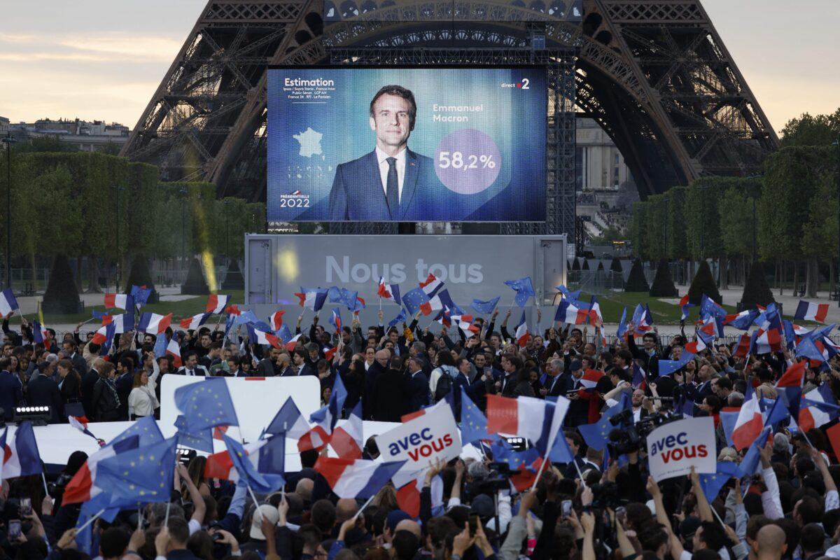 Supporters react after the victory of French President and La Republique en Marche (LREM) party candidate for reelection Emmanuel Macron in France's presidential election, at the Champ de Mars, in Paris, on April 24, 2022. (Ludovic Marin/AFP via Getty Images)