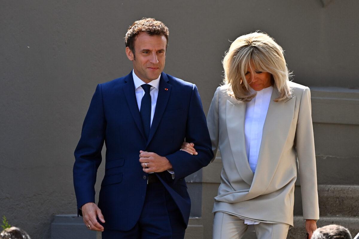 French President Emmanuel Macron salutes voters as he leaves his house with his wife Brigitte Macron to go vote in Le Touquet-Paris-Plage, France, on April 24, 2022. (Aurelien Meunier/Getty Images)