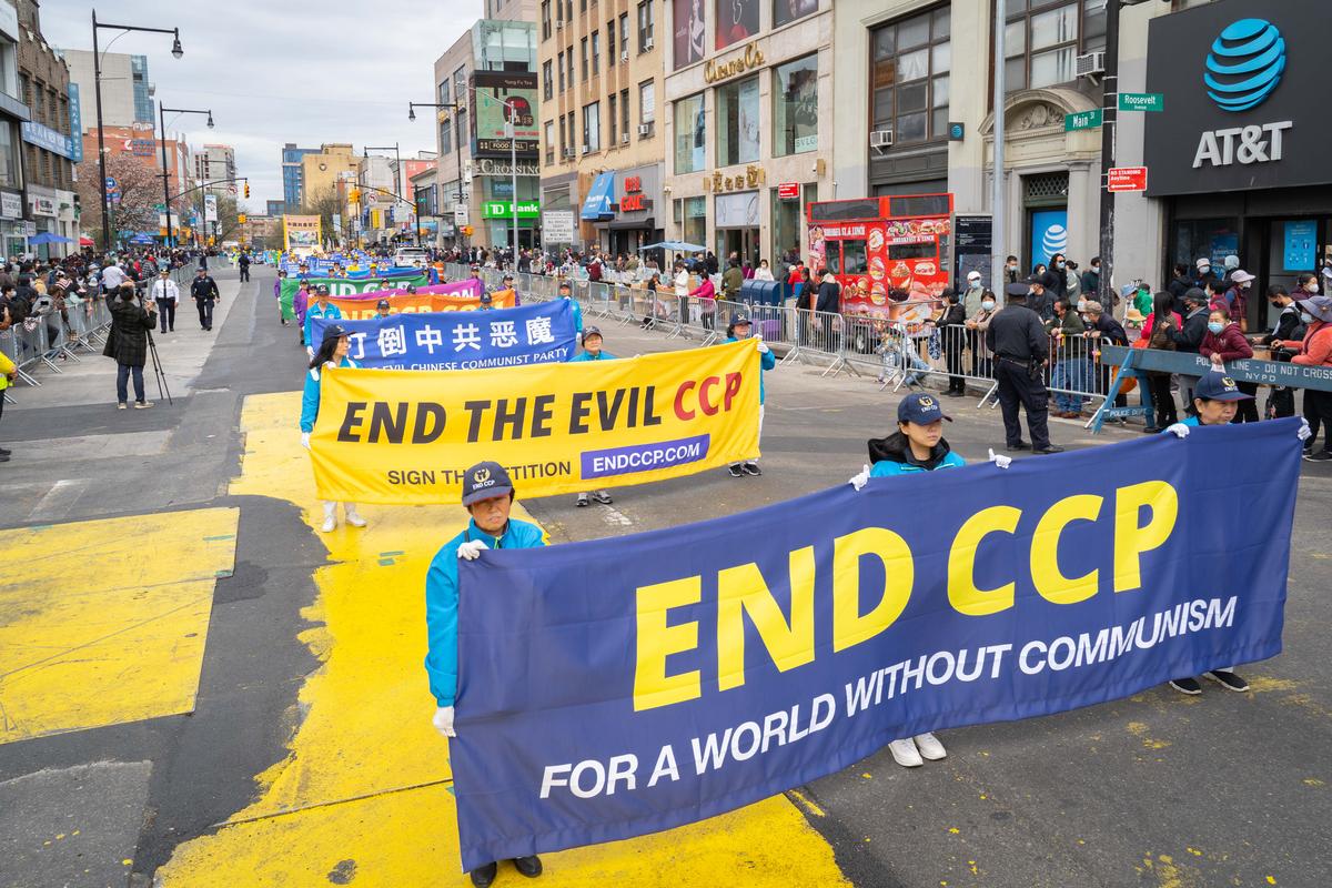 Falun Gong practitioners participate in a parade to commemorate the 23rd anniversary of the April 25th peaceful appeal of 10,000 Falun Gong practitioners in Beijing, in Flushing, N.Y., on April 23, 2022. (Zhang Jingyi/The Epoch Times)