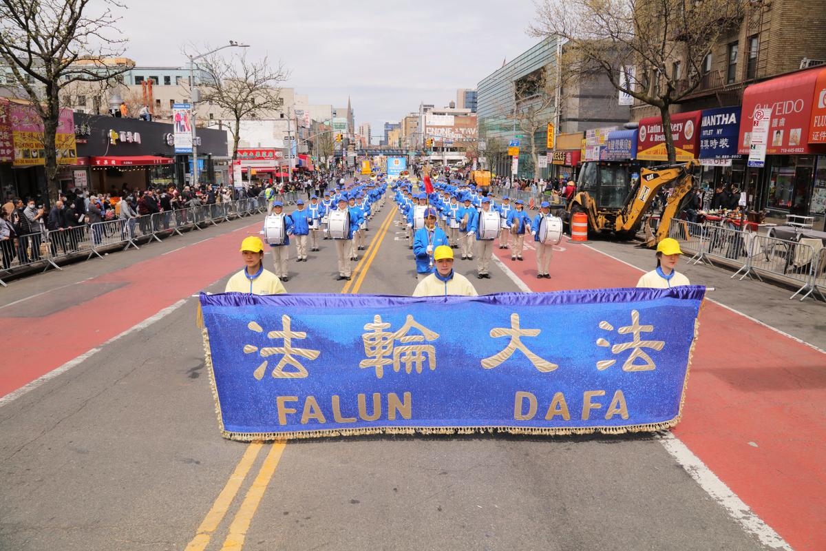Falun Gong practitioners participate in a parade to commemorate the 23rd anniversary of the April 25th peaceful appeal of 10,000 Falun Gong practitioners in Beijing, in Flushing, N.Y., on April 23, 2022. (Zhang Xuehui/The Epoch Times)