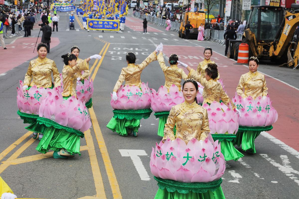 Falun Gong practitioners participate in a parade to commemorate the 23rd anniversary of the April 25th peaceful appeal of 10,000 Falun Gong practitioners in Beijing, in Flushing, N.Y., on April 23, 2022. (Zhang Xuehui/The Epoch Times)