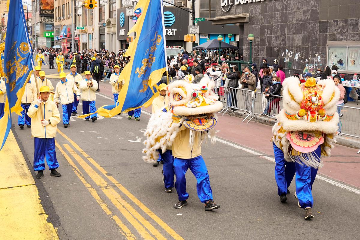 Falun Gong practitioners participate in a parade to commemorate the 23rd anniversary of the April 25th peaceful appeal of 10,000 Falun Gong practitioners in Beijing, in Flushing, N.Y., on April 23, 2022. (Larry Dye/The Epoch Times)