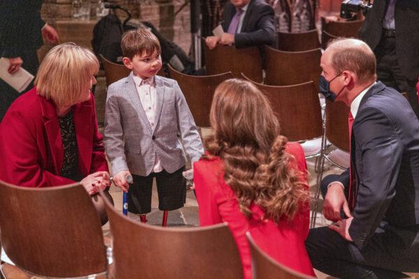 The Duke and Duchess of Cambridge talk to Tony Hudgell and his adoptive mother Paula at Westminster Abbey in London on Dec. 8, 2021. (Heathcliff O'Malley/PA)