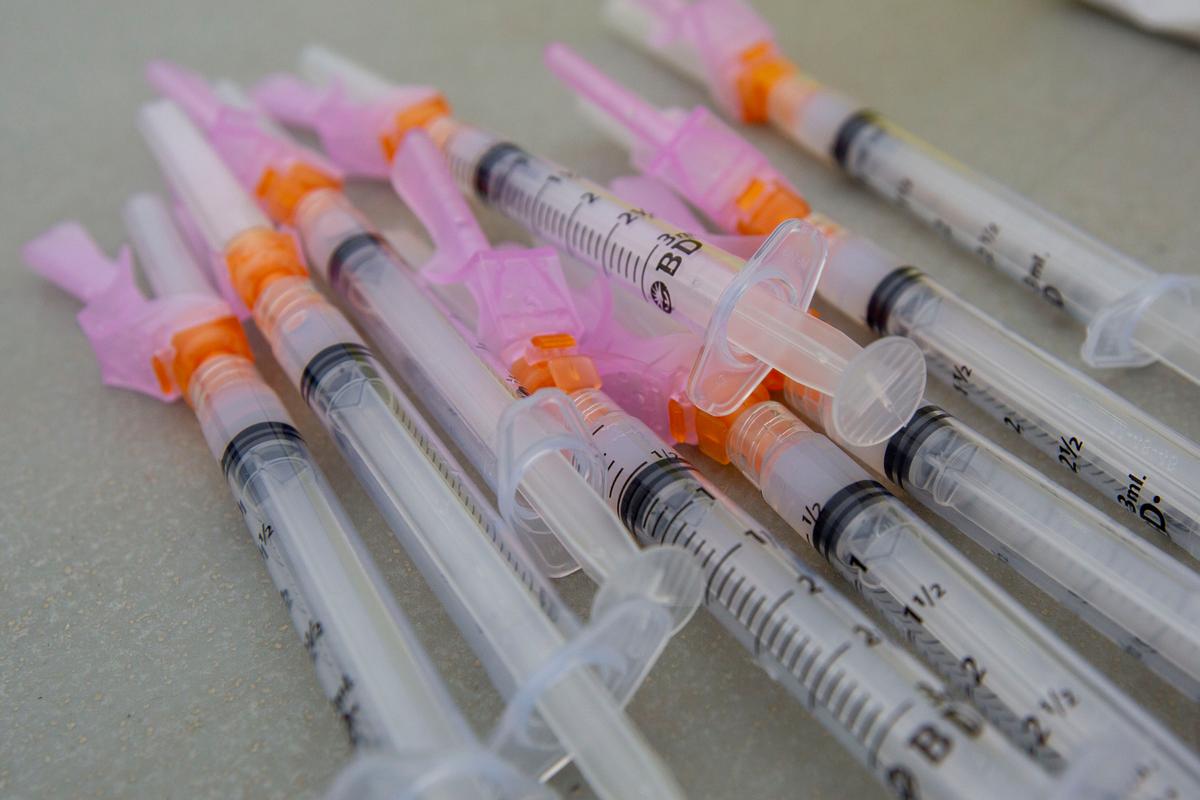  Moderna vaccine syringes lay on a table at a COVID-19 vaccine drive-through clinic at Richardson Stadium in Kingston, Ont., Canada, on May 28, 2021. (The Canadian Press/Lars Hagberg)