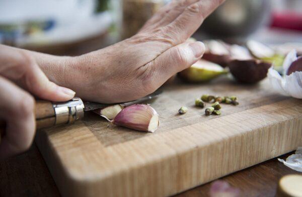 To peel your garlic, you’re going to want to crush the cloves against your countertop. (Photo courtesy of Lucy Lambriex/DigitalVision via Getty Images)