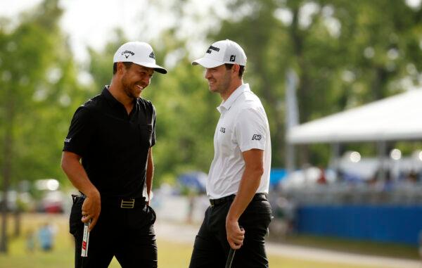 Xander Schauffele and Patrick Cantlay react after putting in to win on the 18th green during the final round of the Zurich Classic of New Orleans at TPC Louisiana, in Avondale, La., on April 24, 2022. (Chris Graythen/Getty Images)