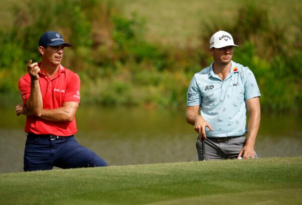 Billy Horschel and Sam Burns check the lie of their ball during the final round of the Zurich Classic of New Orleans at TPC Louisiana, in Avondale, Louisiana, on April 24, 2022. (Chris Graythen/Getty Images)
