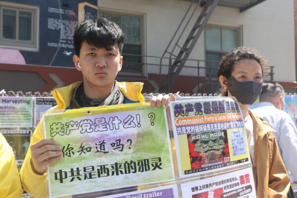 John Wu and Kun Ding hold signs to spread awareness in San Francisco’s Chinatown on April 23, 2022. (David Lam/The Epoch Times)