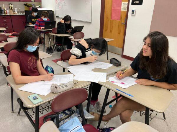 Melissa Li (L), Hailey Lin (C) and Himal Bamzai-Wokhlu<br/>practice solving a math problem as a team as part of their practice at Buchholz High School in Gainesville, Fla., on April 25, 2022 for the upcoming national championship competition in July. (Courtesy of Himal Bamzai-Woklhu)