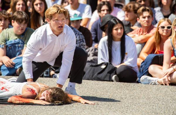 Students at Tesoro High School watch a mock DUI situation in Las Flores, Calif., on April 25, 2022. (John Fredricks/The Epoch Times)