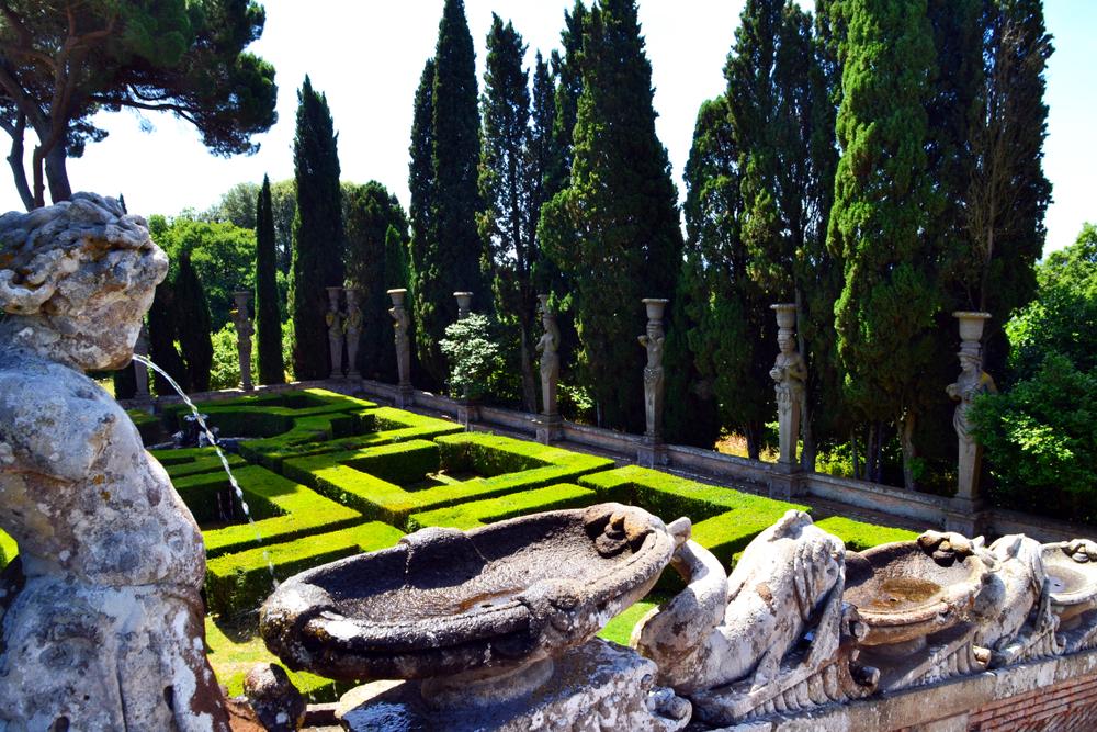 Water flows over a sequence of basins and dolphins down the side of the Dolphin Stairs from the summerhouse to the formal parterre garden below. This part of the terrace is lined by stone herms with cypress trees. (Claudio Caridi/Shutterstock)