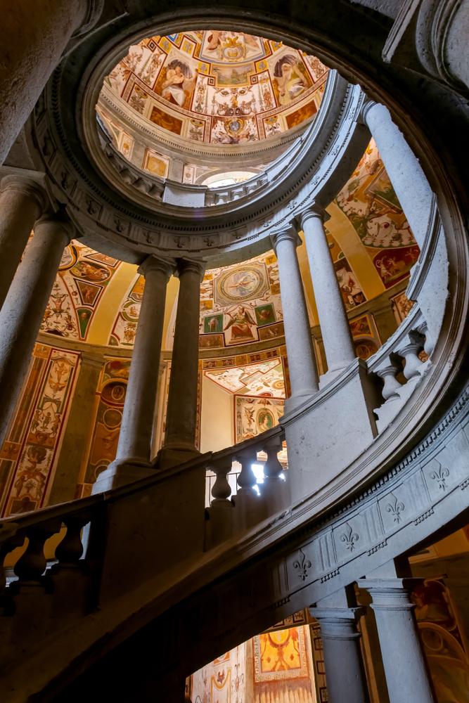 The cylindrical “Scala Regia,” or Royal Stairs, go to the upper floors and are lined with twin doric columns and frescoes. Painted by Antonio Tempesta, the frescoes display the virtues of Cardinal Allesandro Farnese to guests as they mount the stairs. (ClaudioBottoni/Shutterstock)