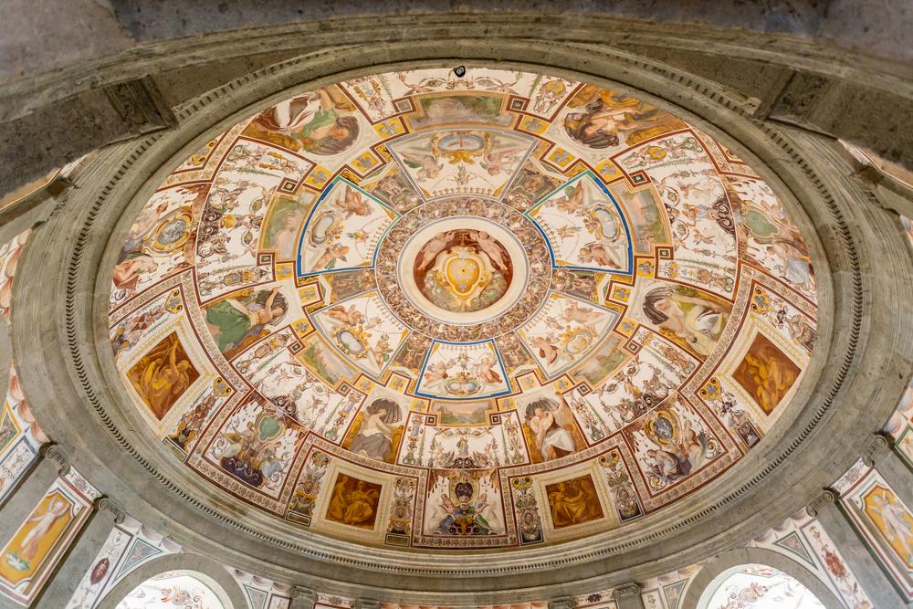 The staircase climaxes with a majestic dome painted by Antonio Tempesta. The Farnese coat of arms is at the center, surrounded by allegorical decorations. (DinoPh/Shutterstock)