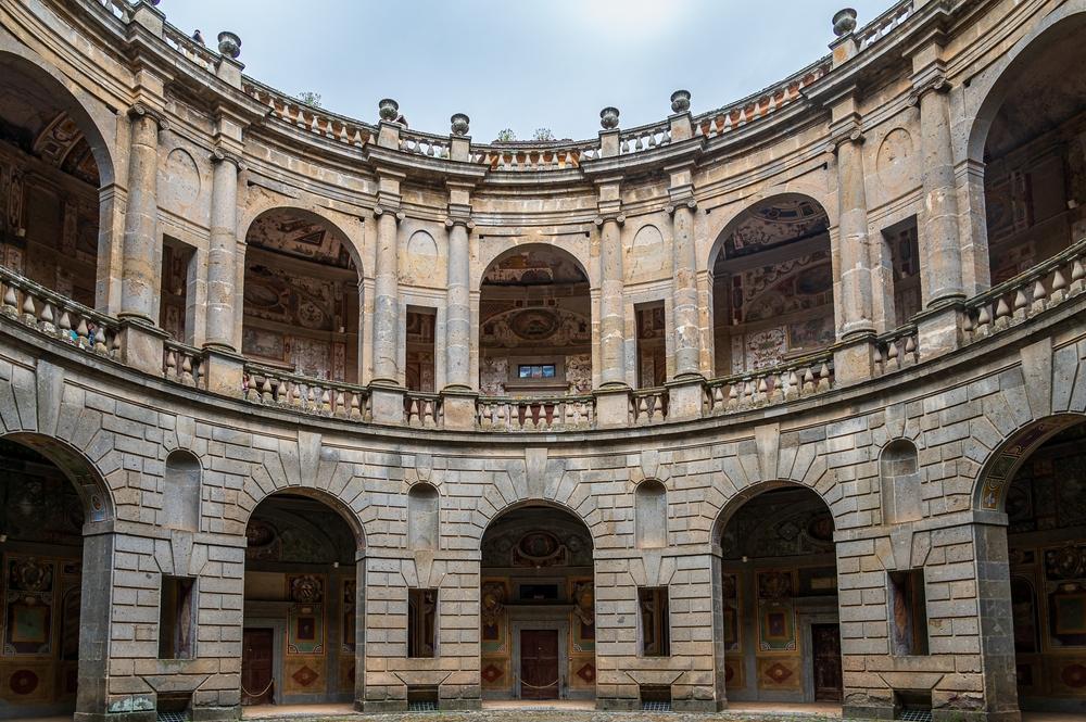 The circular courtyard holds a powerful presence, as it's the focus of each room that opens onto it via an arcade on both levels. The arched openings create a rhythm that flows around the courtyard. The lower level offers a bold foundation for the pairs of Ionic columns on the upper level to then project vertically to the heavens. (Fabio Lotti/Shutterstock)