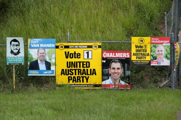Federal election campaign posters are seen in Kingston, south of Brisbane, Australia, on April 22, 2022. (AAP Image/Jono Searle)
