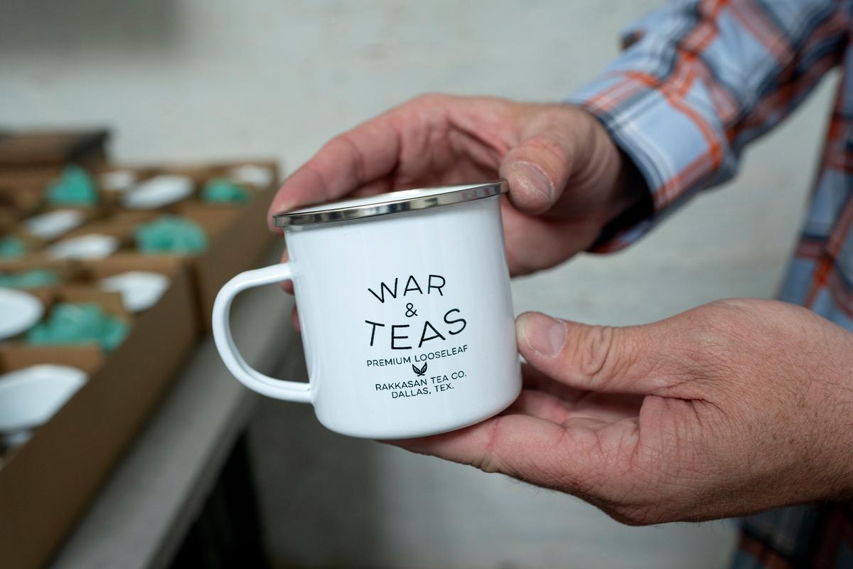 TK Kamauf holds a Rakkasan Tea branded tea cup on April 23, 2021, at the company's new brick-and-mortar store, in Dallas. (Jeffrey McWhorter/Dallas Morning News/TNS)