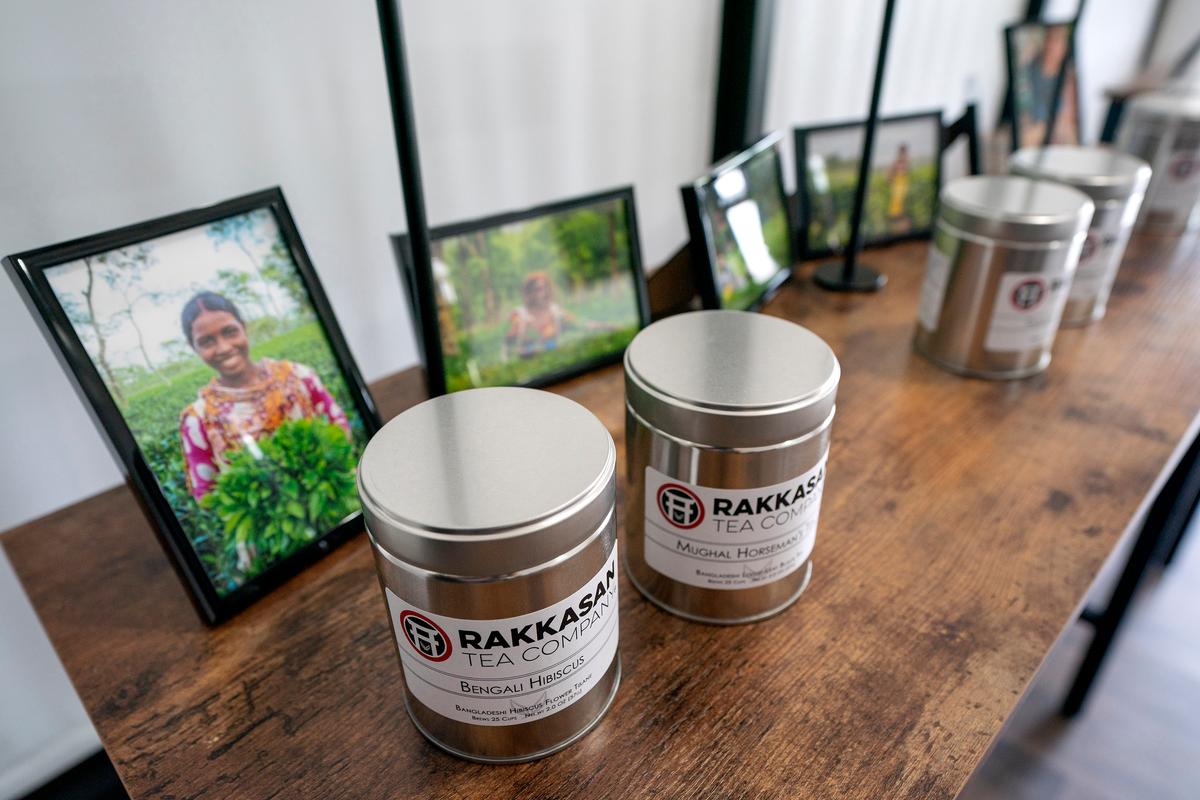 Canisters of Rakkasan Tea sit in front of photos of tea growers from the countries where the tea was sourced Friday, April 23, 2021, at the company's new brick-and-mortar store, in Dallas. (Jeffrey McWhorter/Dallas Morning News/TNS)