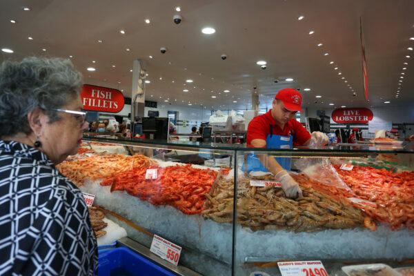 A shopper purchases prawns from Claudio's Seafood at the Sydney Fish Market in Sydney, Australia, on April 14, 2022. (Lisa Maree Williams/Getty Images)
