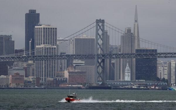 A U.S. Coast Guard boat passes in front of the San Francisco Skyline in Oakland, Calif. on June 20, 2018. (Justin Sullivan/Getty Images)