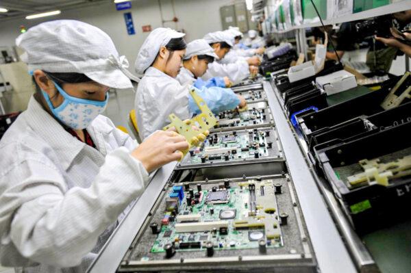 Chinese workers assemble electronic components at the Taiwanese technology giant Foxconn's factory in Shenzhen City, Guangdong Province, China, on May 26, 2010. (AFP/AFP/Getty Images)