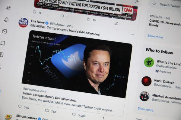 A photo illustration with news about Elon Musk's bid to takeover Twitter is tweeted in Chicago, on April 25, 2022. (Scott Olson/Getty Images)