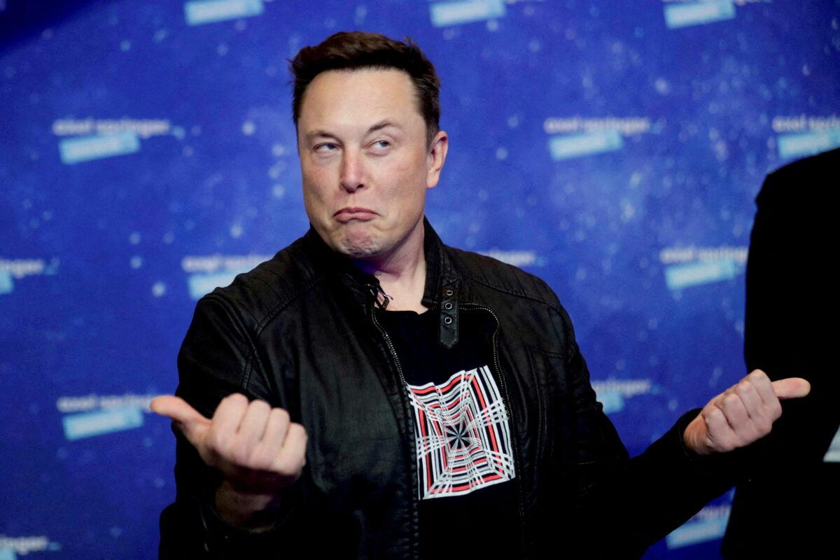 Tesla CEO Elon Musk—who is buying Twitter for $44 billion—grimaces after arriving on the red carpet for the Axel Springer award in Berlin, Germany, on Dec. 1, 2020. (Hannibal Hanschke/Reuters)