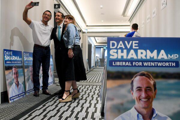 Liberal Member for Wentworth Dave Sharma (centre) posing for a photograph with supporters during the official launch of his re-election campaign, in Sydney, Australia, on March 27, 2022. (AAP Image/Bianca De Marchi)