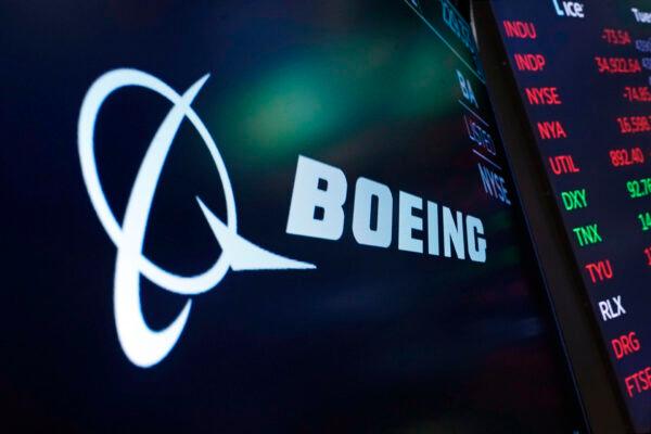  The logo for Boeing appears on a screen above a trading post on the floor of the New York Stock Exchange on July 13, 2021. (Richard Drew/AP Photo/file)