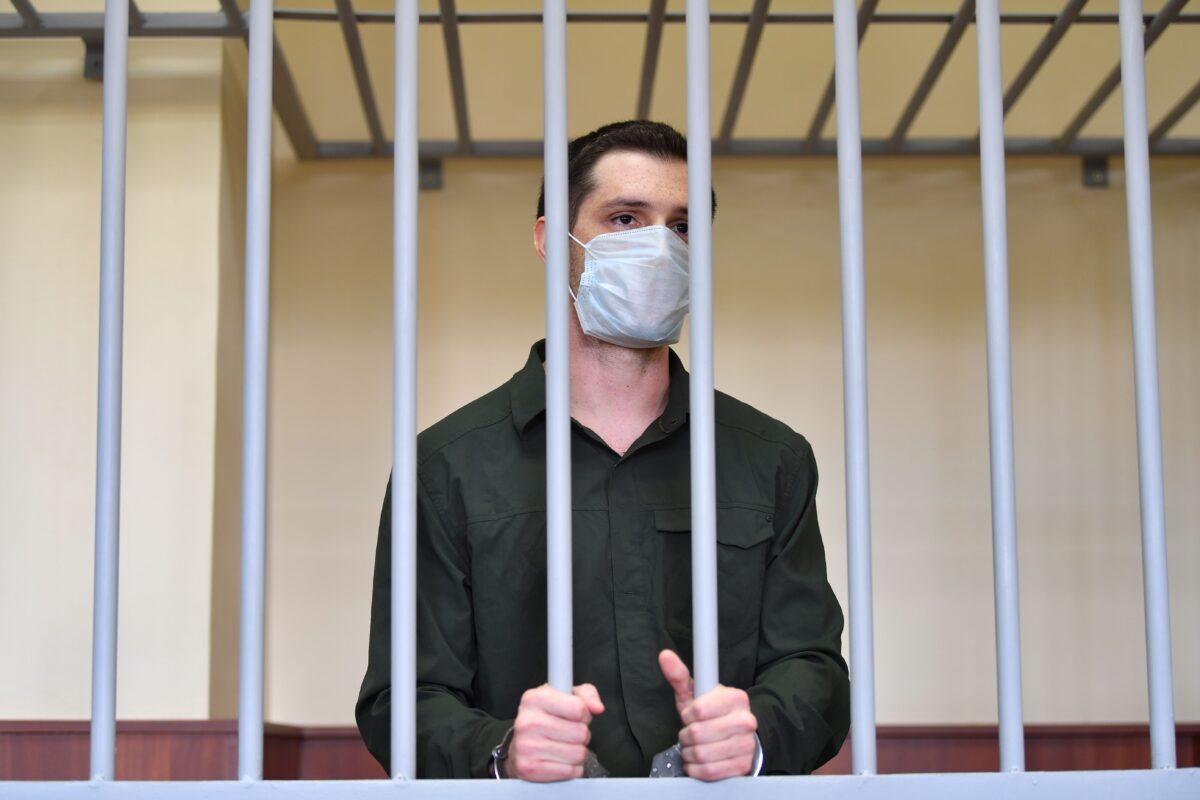 U.S. ex-marine Trevor Reed, charged with attacking police, stands inside a defendants' cage during his verdict hearing at Moscow's Golovinsky district court on July 30, 2020. (Dimitar Dilkoff/AFP via Getty Images)