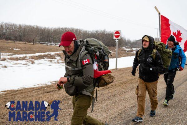 James Topp, flanked by members of his team, walks near Qu'Appelle, Sask., during a march to Ottawa in protest of vaccine mandates, April 21, 2022. (Courtesy Logan Murphy)