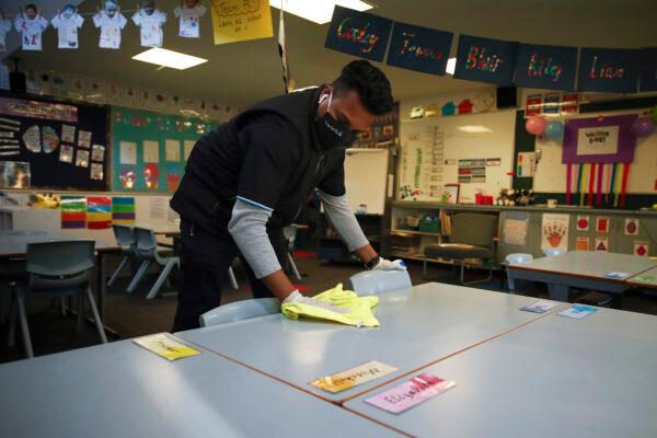 A cleaner is seen cleaning high-touch areas in preparation for students returning to Lysterfield Primary School in Melbourne, Australia, on May 25, 2020. (Daniel Pockett/Getty Images)